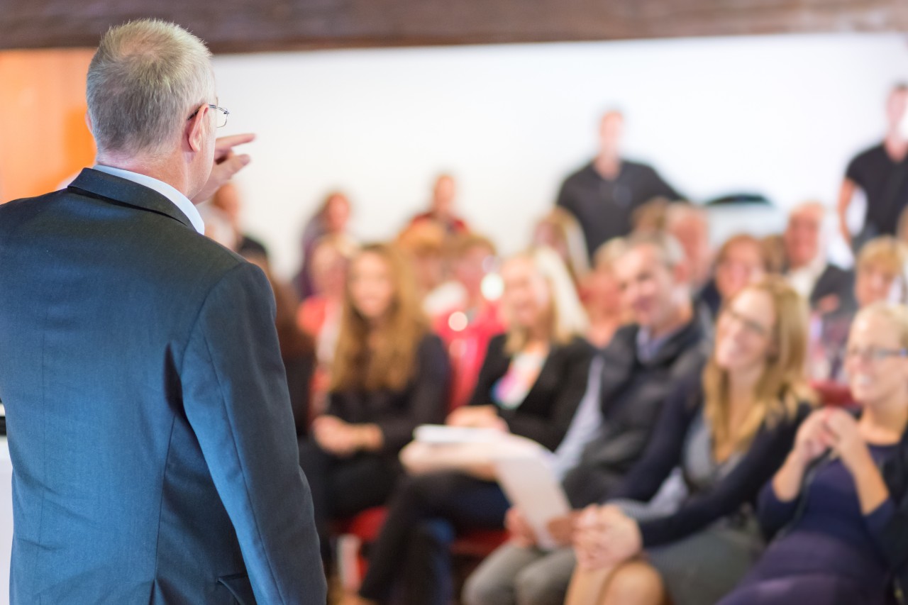 Business man leading a business workshop. Corporate executive delivering a presentation to his colleagues during meeting or in-house business training. Business and entrepreneurship concept.