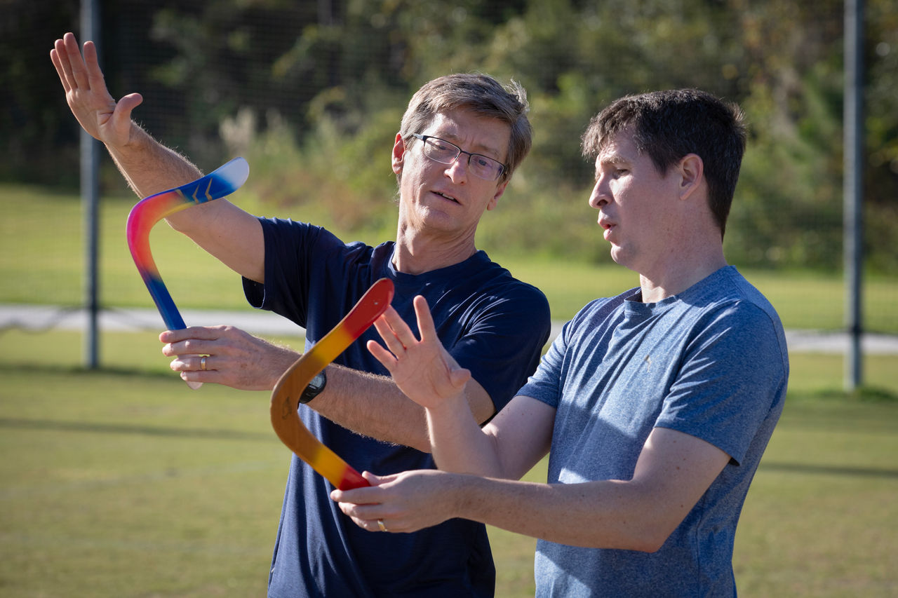 men together with boomerang