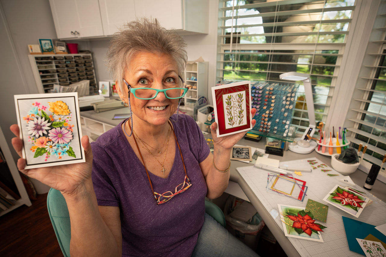 woman holding cards in each hand